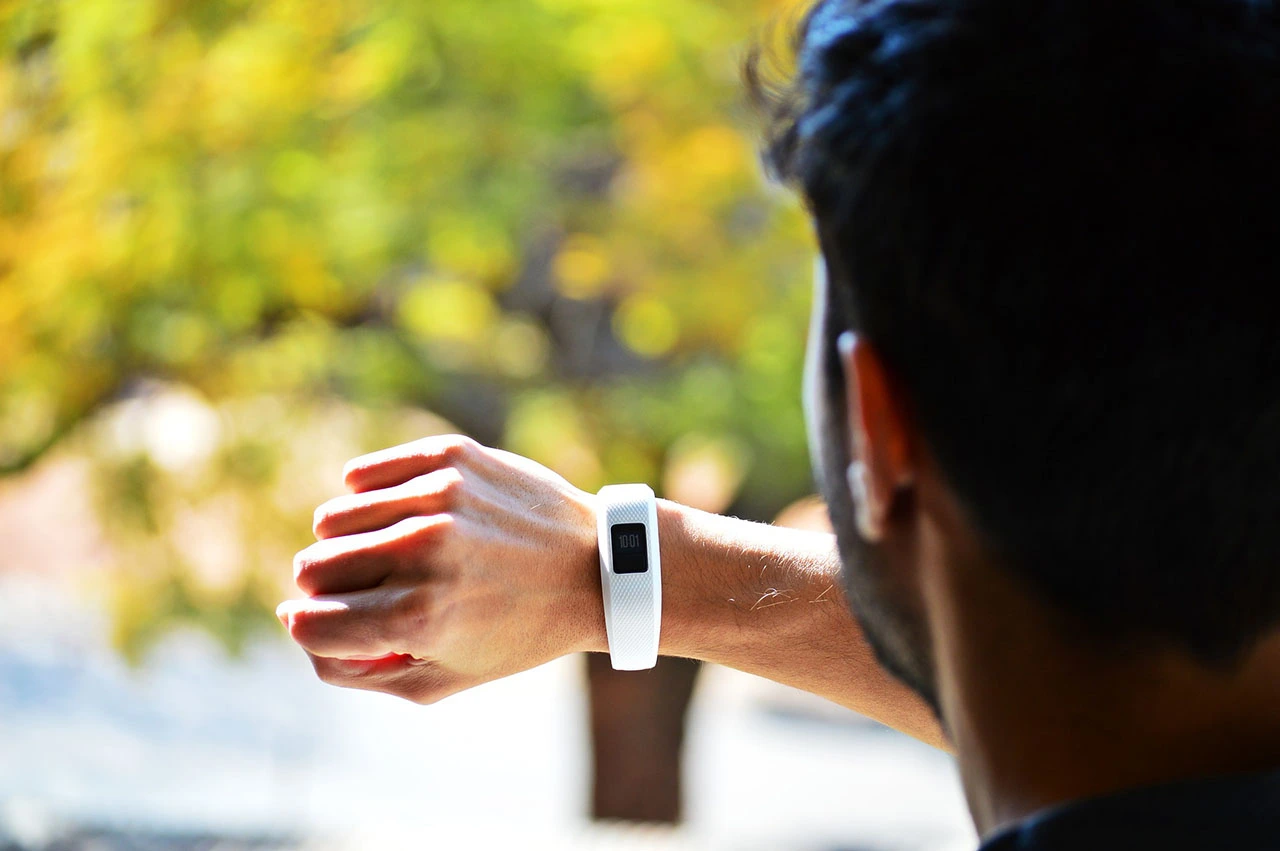 Person checking fitness tracker on wrist